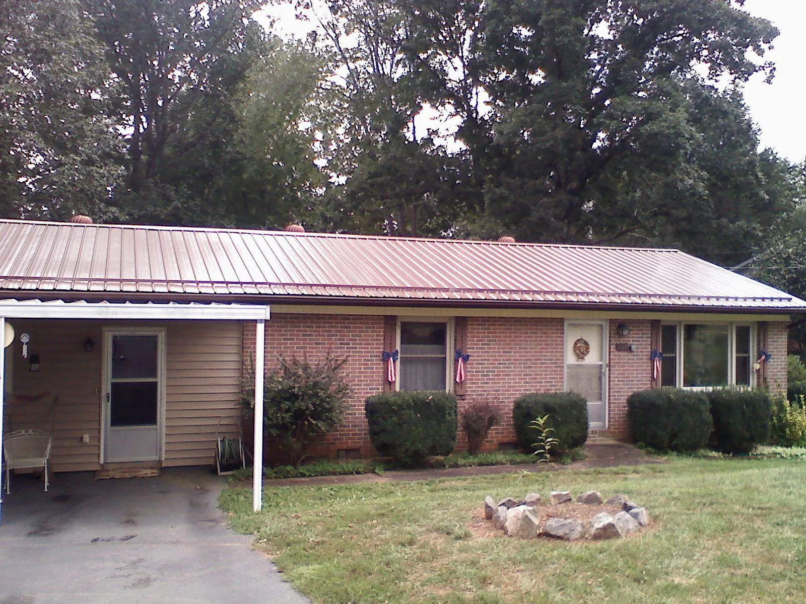 Bronze metal roof and carport on a brick ranch home — Roof Repair work by our crew in New Oxford