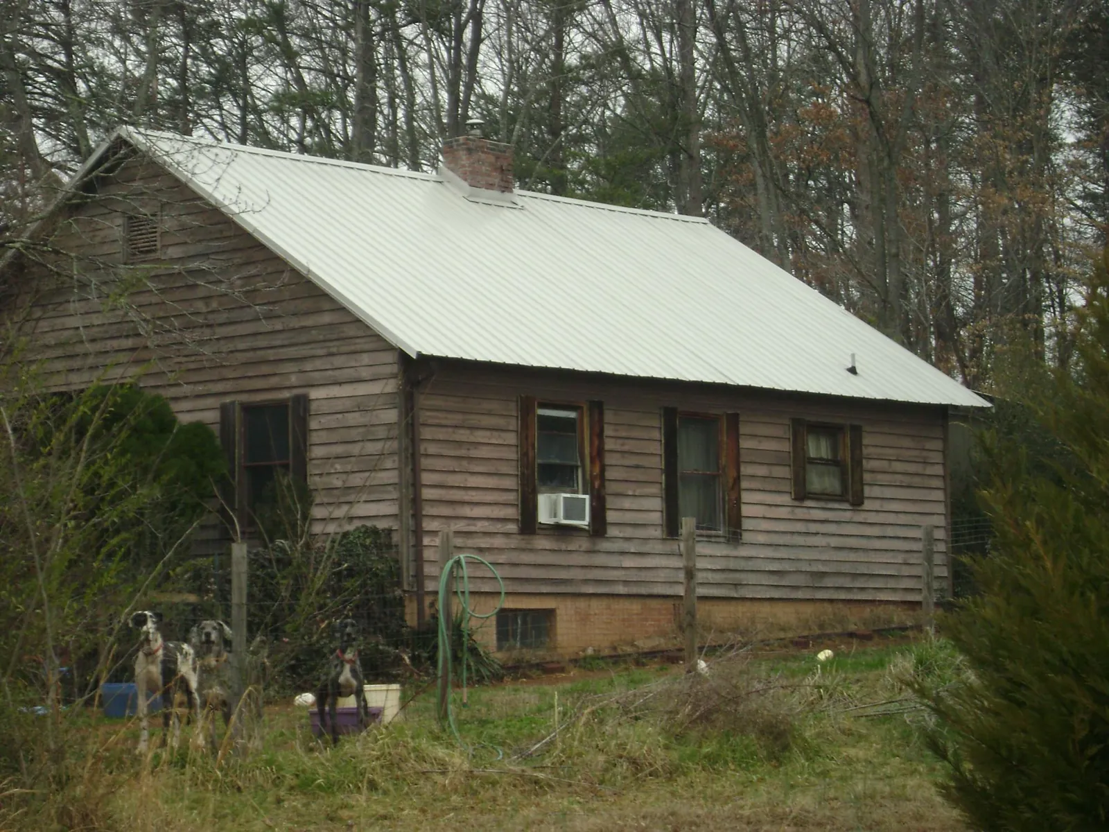 White metal roof on an old wood sided farmhouse, from a Metal Roof Installation job in New Oxford